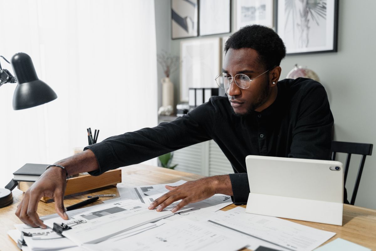 Professional reviewing financial documents with a tablet