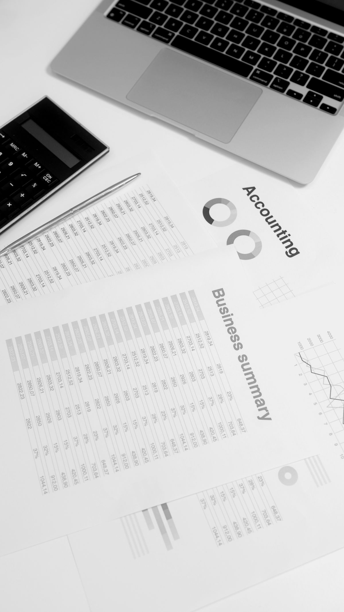 Financial analysis workspace with laptop and calculator