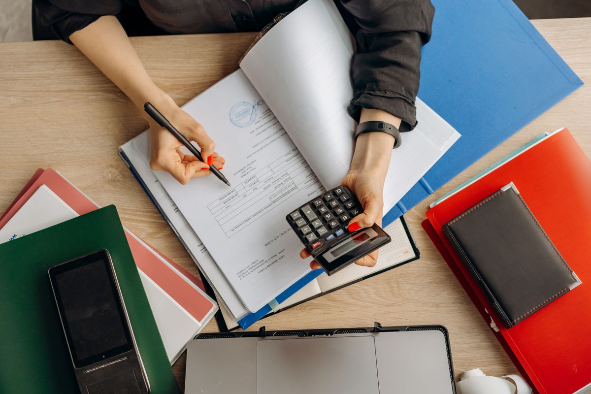 Financial documents reviewed with a calculator